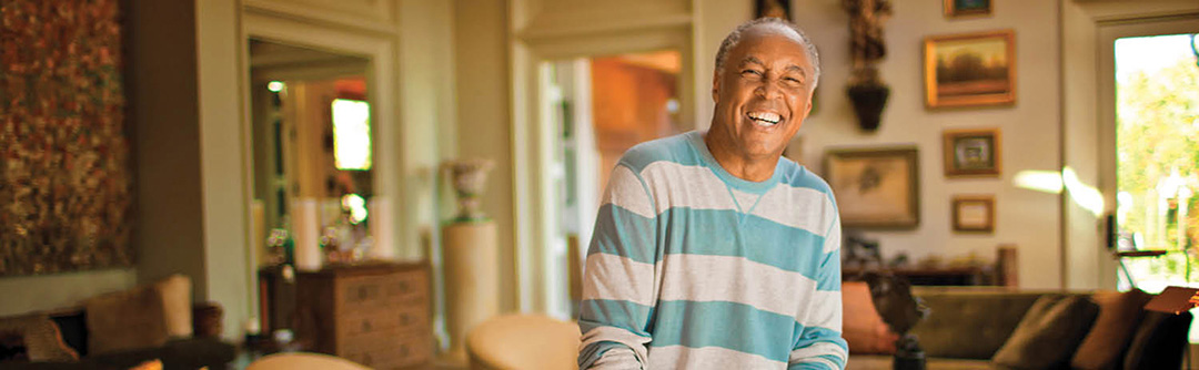 A man smiling in his living room