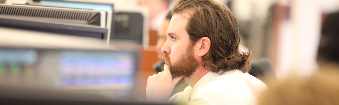 Man sitting in an office looking at his computer