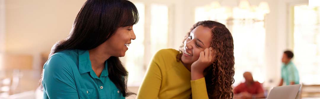 Woman smiling with adolescent woman
