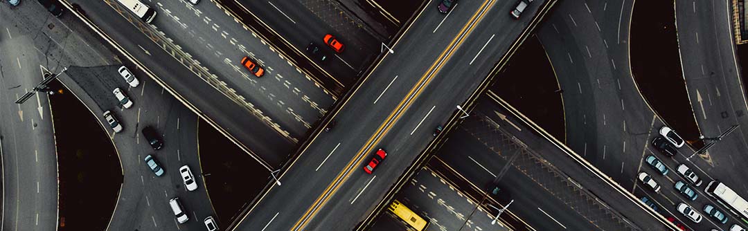 Birds eye view of cars driving on multiple overpasses