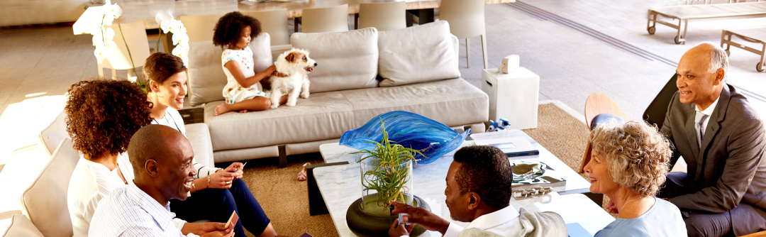 Multigenerational family seated in living room.