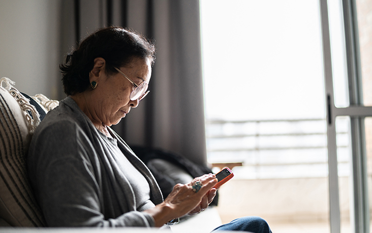 Woman looking at cell phone making sure she knows who is calling