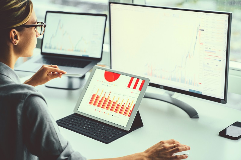 woman looking into monitor with financial data