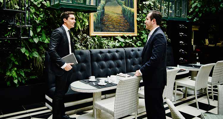 Two businesspeople meet at a cafe