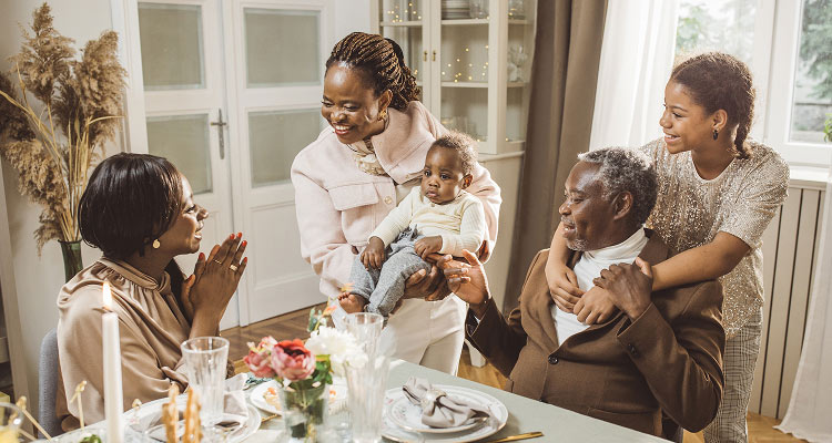 Family with child and baby at gathering.
