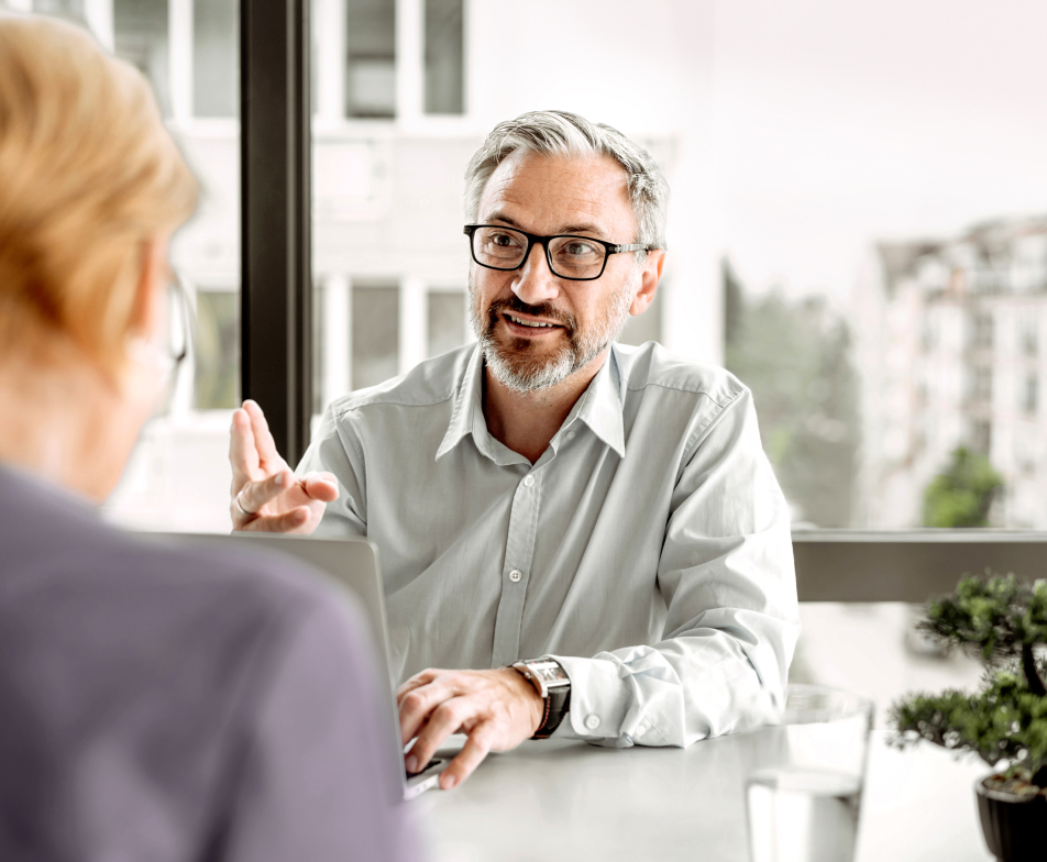 two people having a conversation at a table