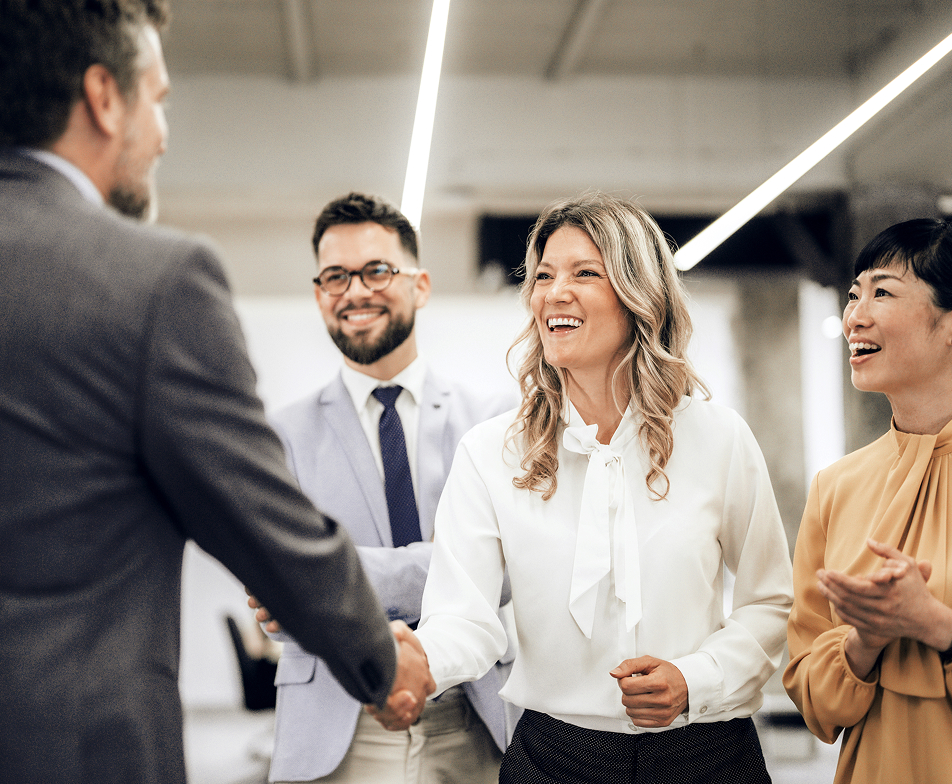 group of people with two people shaking hands