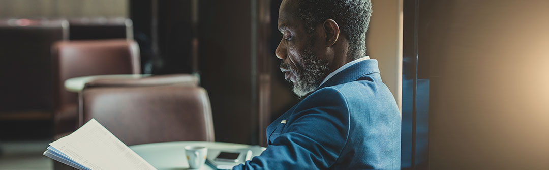 Man sitting down looking at documents