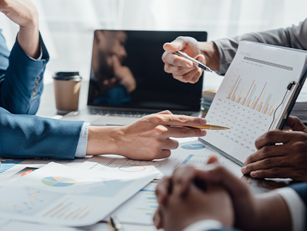 Financial professionals reviewing charts and analytics illustrating  investment performance and margin lending benefits