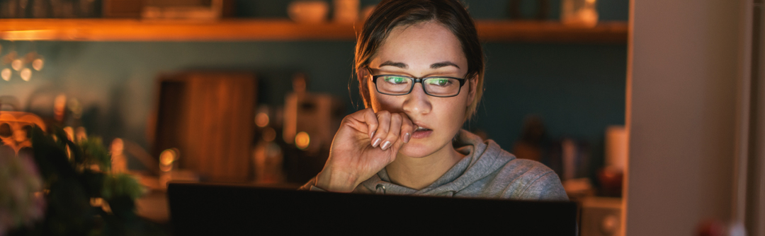 Concerned woman viewing laptop