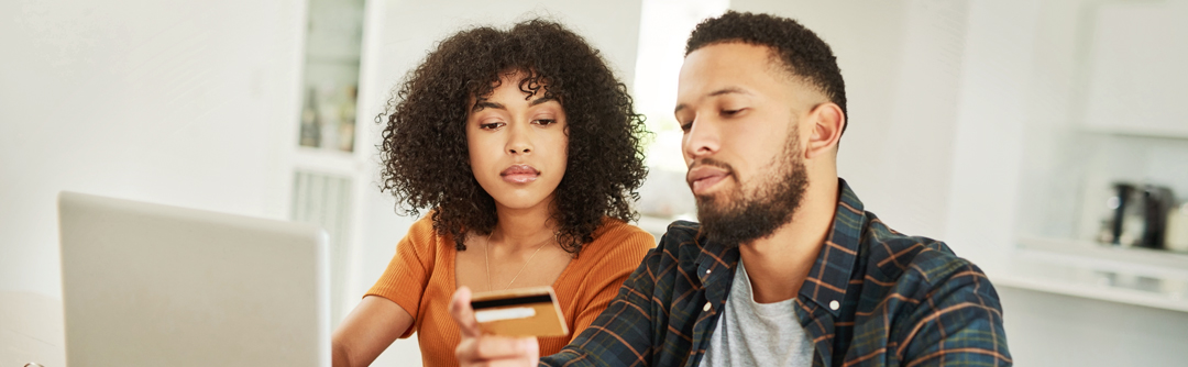 Woman and man looking at credit card