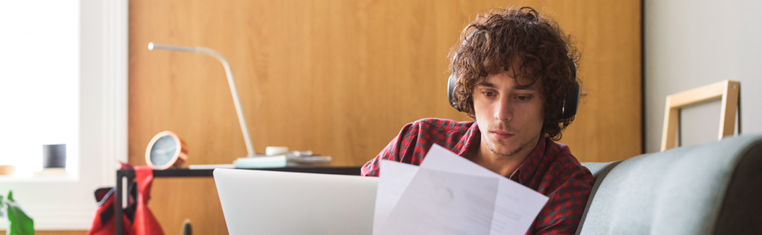 Man reviewing documents at laptop